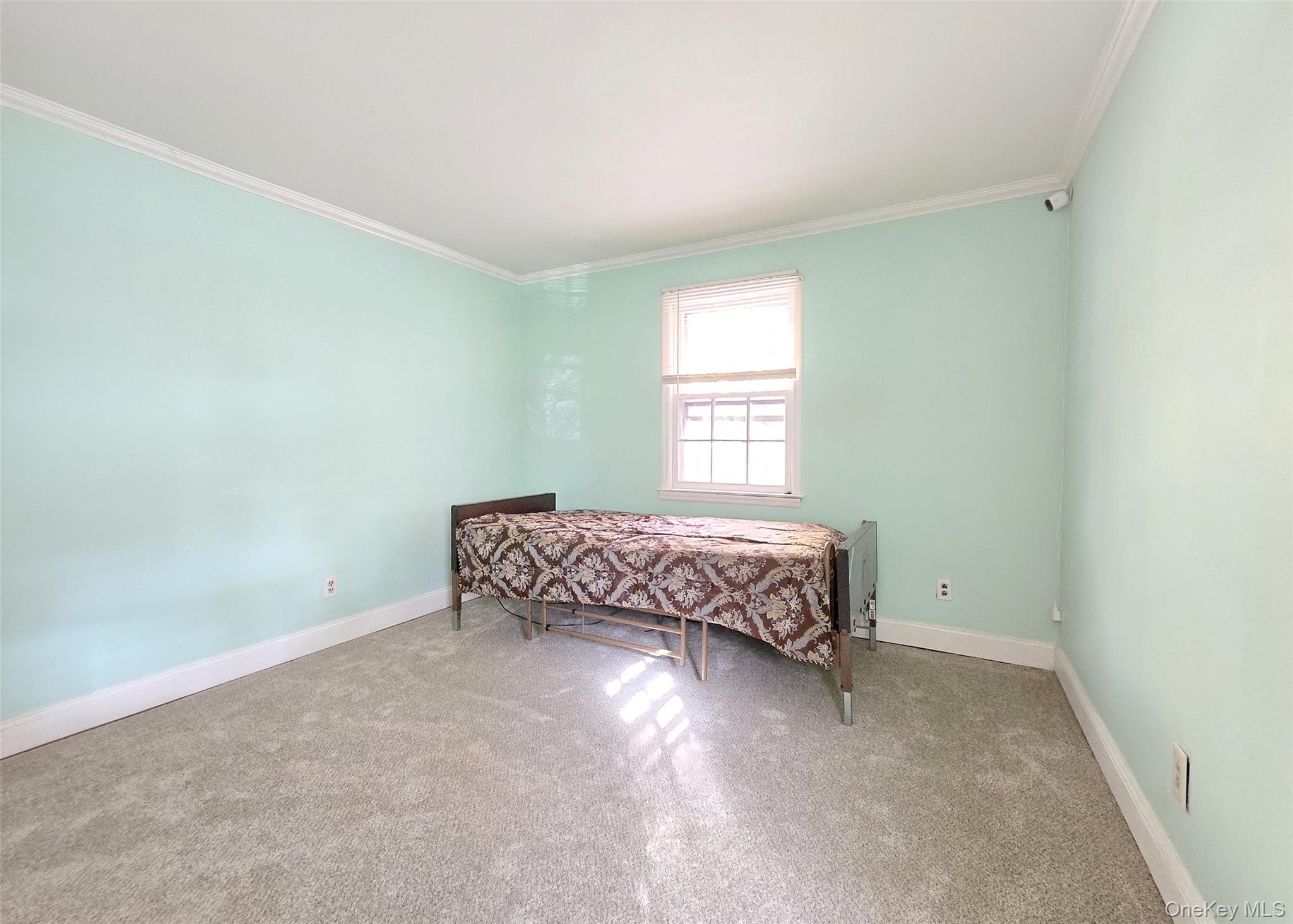 585 Pulaski Road Kings Park, NY 11754 - Photo 16 of 28 a room with a bed and a window