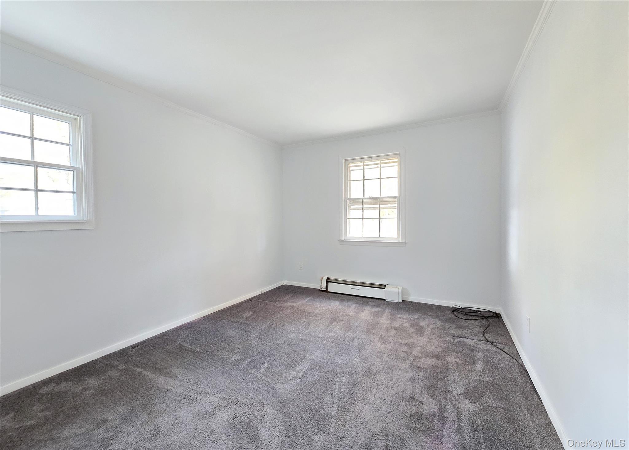 585 Pulaski Road Kings Park, NY 11754 - Photo 17 of 28 an empty room with windows