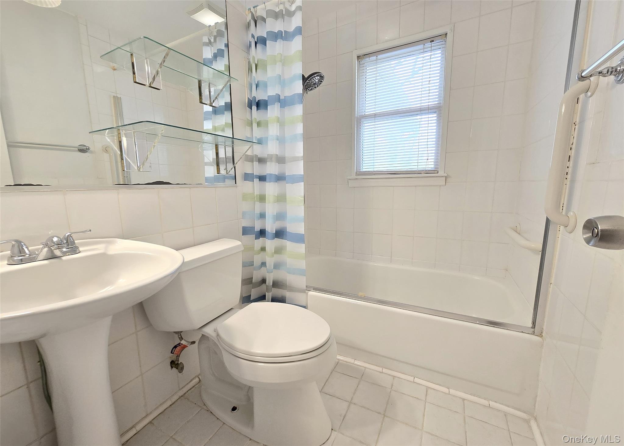 585 Pulaski Road Kings Park, NY 11754 - Photo 21 of 28 a bathroom with a sink a toilet and shower