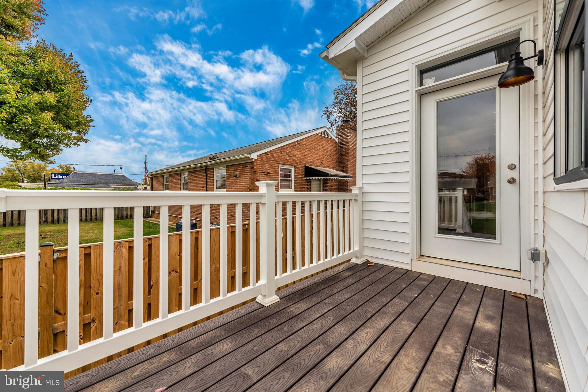 16 North Lot Easton, MD 21601 - Photo 5 of 44 Sunny deck with a view of lush greenery.