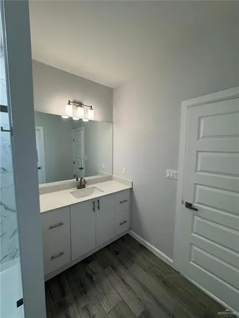 a bathroom with a double vanity sink and mirror