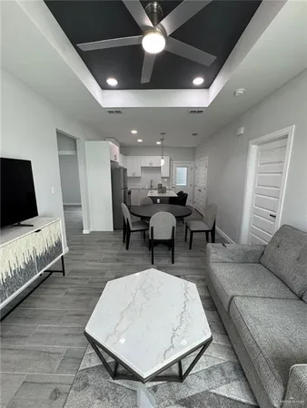 a living room with furniture and a wooden floor