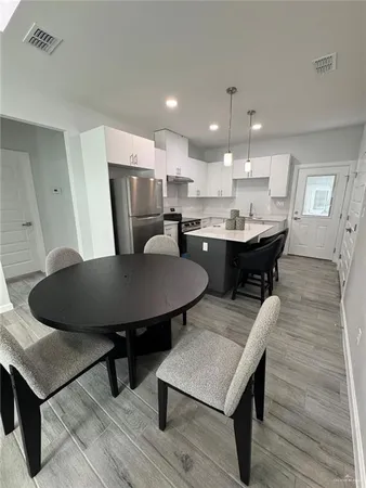 a view of a dining room with furniture and wooden floor