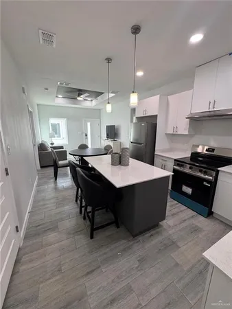 a kitchen with a table chairs and a refrigerator