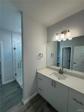 a bathroom with a double vanity sink and mirror