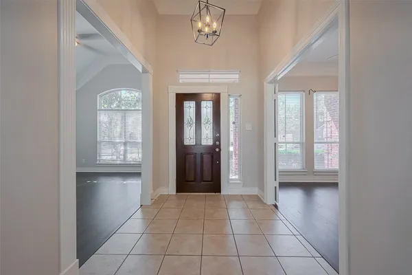 a view of an empty room with a fireplace and a window