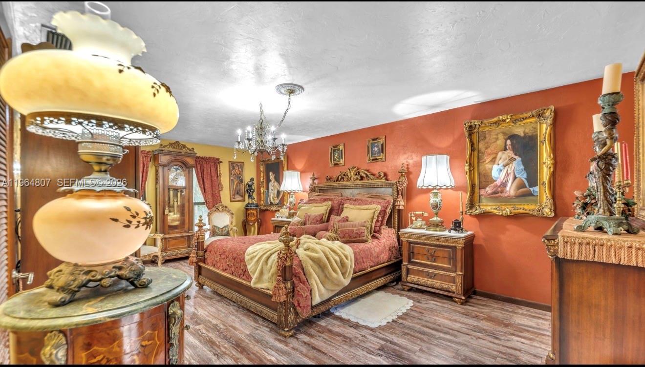 15425 Southwest 268th Street Homestead, FL 33032 - Photo 17 of 62 a bedroom with bed and a mirror