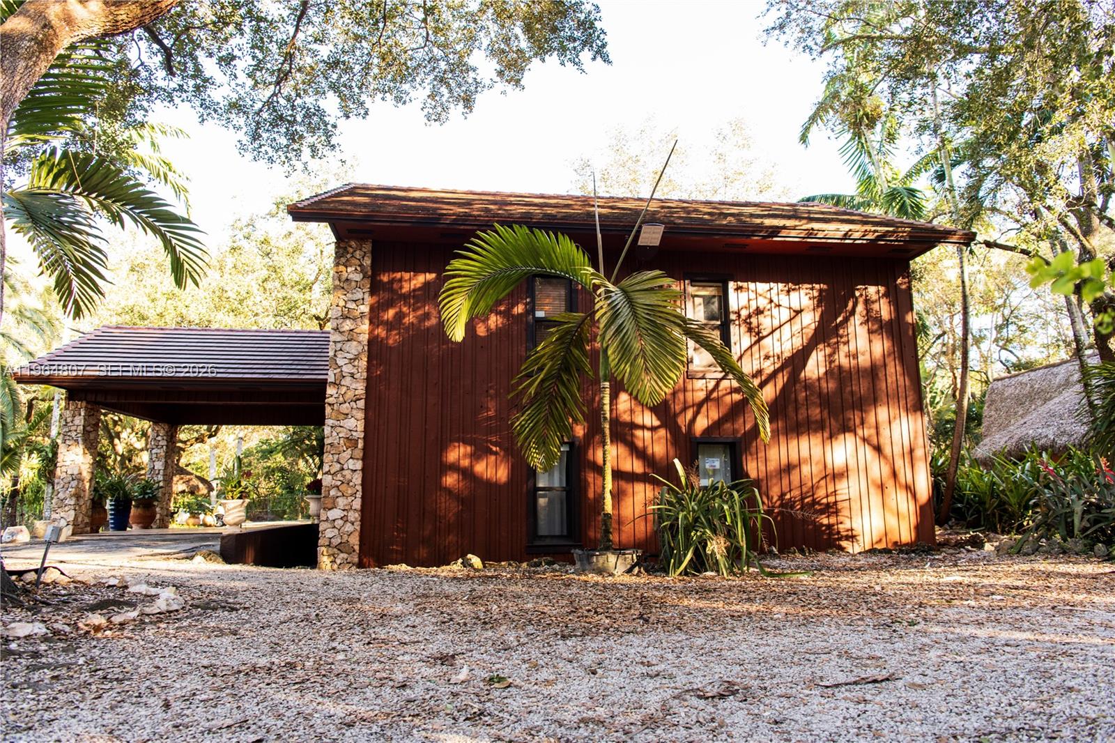 15425 Southwest 268th Street Homestead, FL 33032 - Photo 29 of 62 a view of a patio with a table and chairs under an umbrella