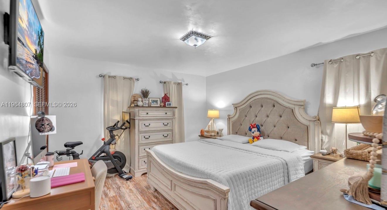 15425 Southwest 268th Street Homestead, FL 33032 - Photo 37 of 62 a bedroom with a bed and a chandelier