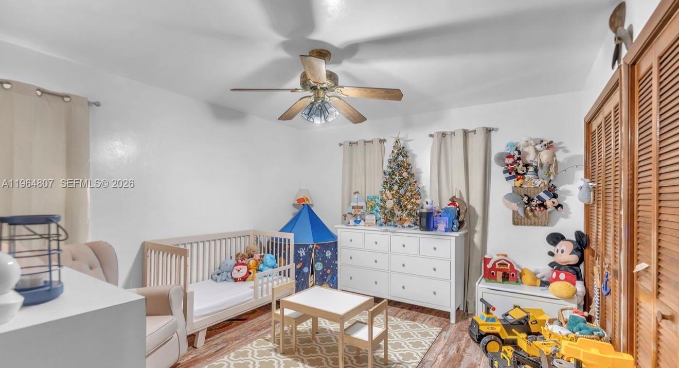 15425 Southwest 268th Street Homestead, FL 33032 - Photo 38 of 62 a bedroom with furniture and a chandelier fan