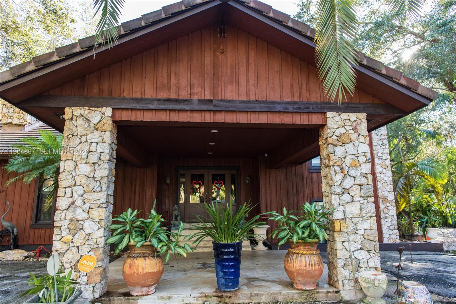15425 Southwest 268th Street Homestead, FL 33032 - Photo 4 of 62 a house with a flower garden