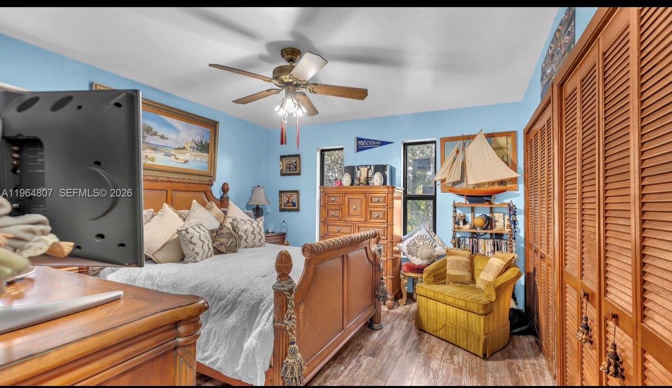 15425 Southwest 268th Street Homestead, FL 33032 - Photo 44 of 62 a bedroom with furniture and wooden floor