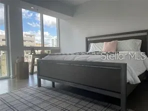 a bedroom with a bed and window