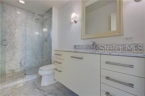 1350 Main Street, Unit 304 Sarasota, FL 34236 - Photo 8 of 14 a bathroom with a sink a toilet and shower