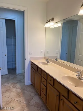 a bathroom with a double vanity sink and a mirror