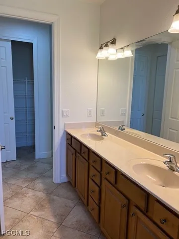 a bathroom with a double vanity sink and a mirror