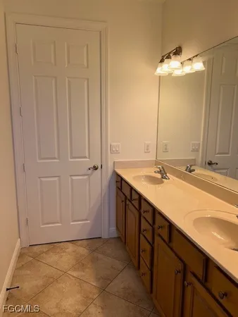 a bathroom with a double vanity sink and a mirror