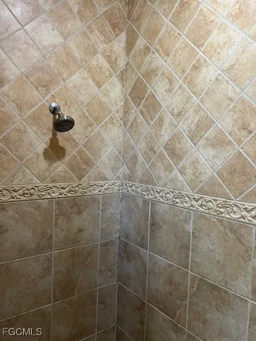 a white toilet sitting next to a white wall