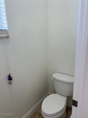 a white toilet sitting next to a sink