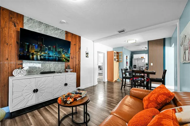 a kitchen with stainless steel appliances kitchen island granite countertop a stove a refrigerator and a microwave