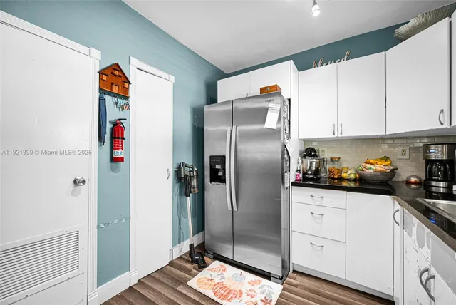 a kitchen with stainless steel appliances granite countertop a stove and a refrigerator
