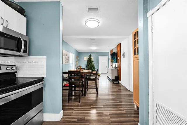 a view of a dining room with furniture and wooden floor