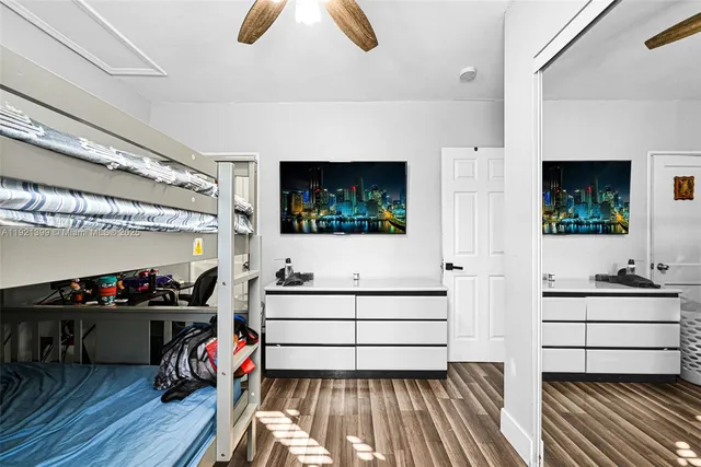 a living room with furniture a piano and a flat screen tv