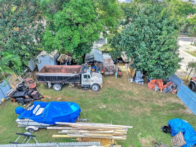 a view of a patio with a table and chairs with wooden fence