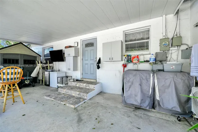 a backyard of a house with table and chairs