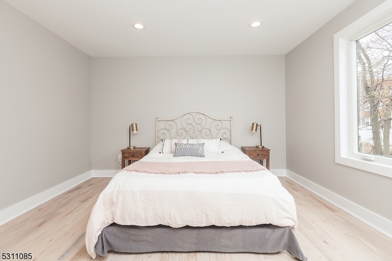 27 Mission Street, Unit 2 Montclair, NJ 07042 - Photo 11 of 18 a large white bed in a room next to a window