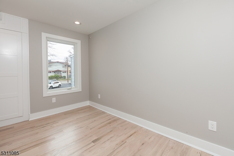 27 Mission Street, Unit 2 Montclair, NJ 07042 - Photo 12 of 18 a view of an empty room with wooden floor and a window