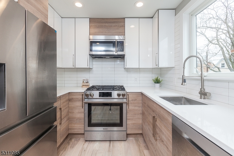 27 Mission Street, Unit 2 Montclair, NJ 07042 - Photo 6 of 18 a kitchen with stainless steel appliances granite countertop a sink stove and refrigerator