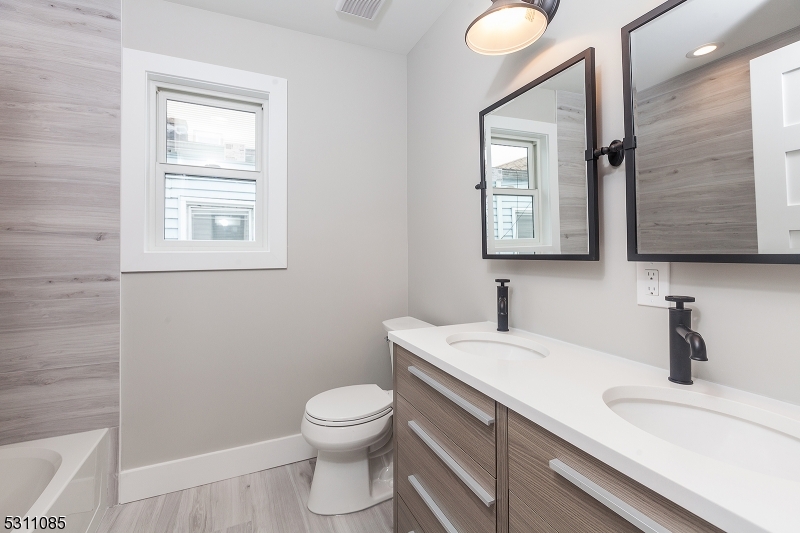 27 Mission Street, Unit 2 Montclair, NJ 07042 - Photo 8 of 18 a bathroom with a toilet sink and mirror