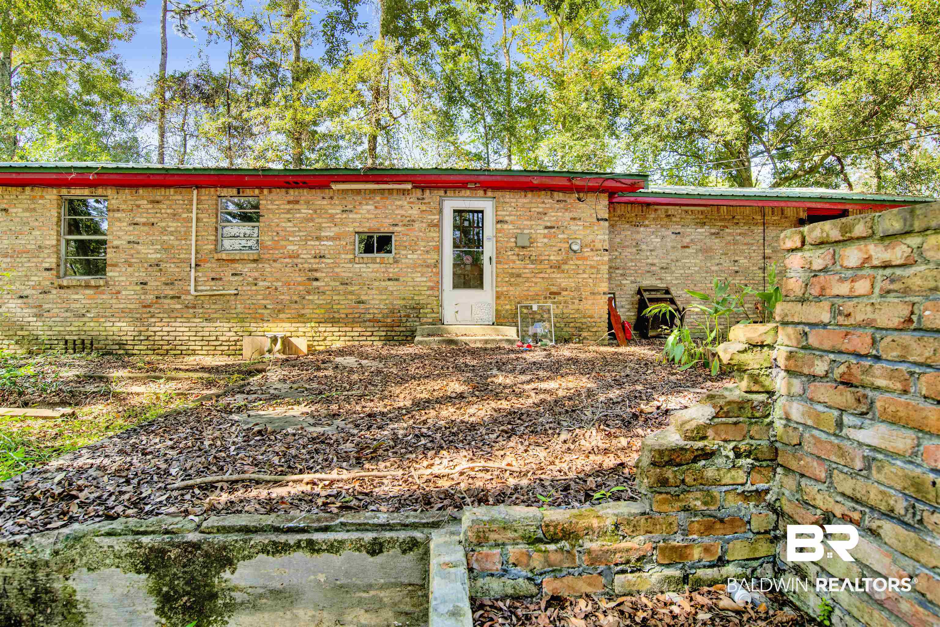 7623 Old Shell Road Mobile, AL 36608 - Photo 9 of 12 Back of property with brick siding and crawl space