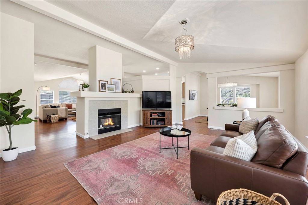 37055 De Portola Road Temecula, CA 92592 - Photo 32 of 67 a living room with furniture a flat screen tv and a fireplace