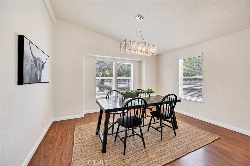 37055 De Portola Road Temecula, CA 92592 - Photo 34 of 67 a view of a dining room with furniture window and wooden floor
