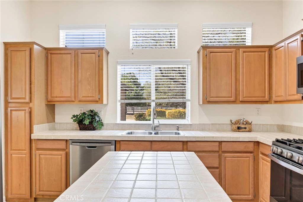 37055 De Portola Road Temecula, CA 92592 - Photo 37 of 67 a kitchen with stainless steel appliances a counter top space and a window