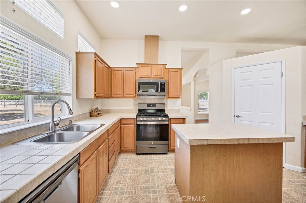 37055 De Portola Road Temecula, CA 92592 - Photo 38 of 67 a kitchen with stainless steel appliances granite countertop a sink and stove