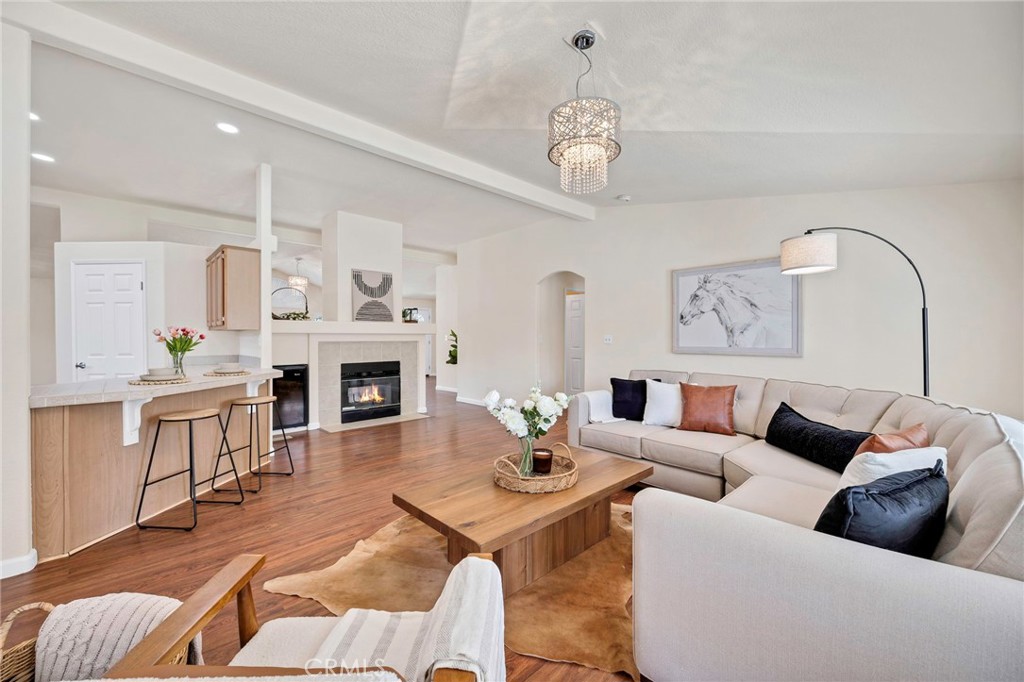 37055 De Portola Road Temecula, CA 92592 - Photo 42 of 67 a living room with furniture a fireplace and a chandelier