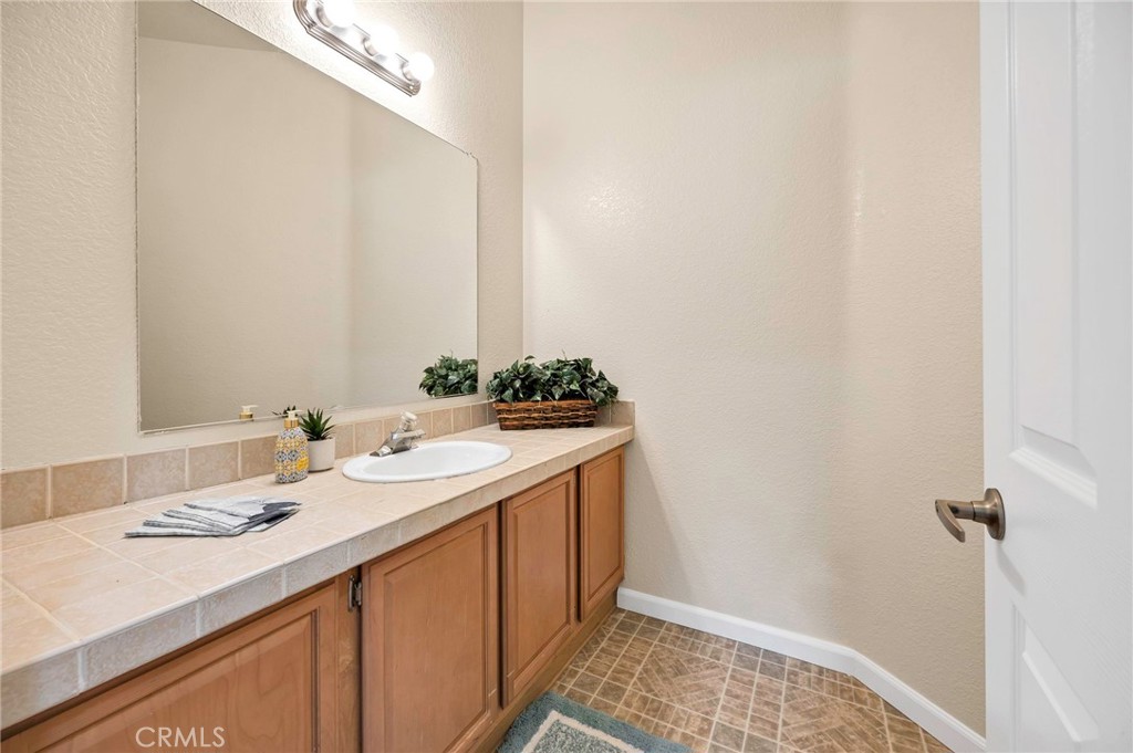 37055 De Portola Road Temecula, CA 92592 - Photo 47 of 67 a bathroom with a sink and a mirror