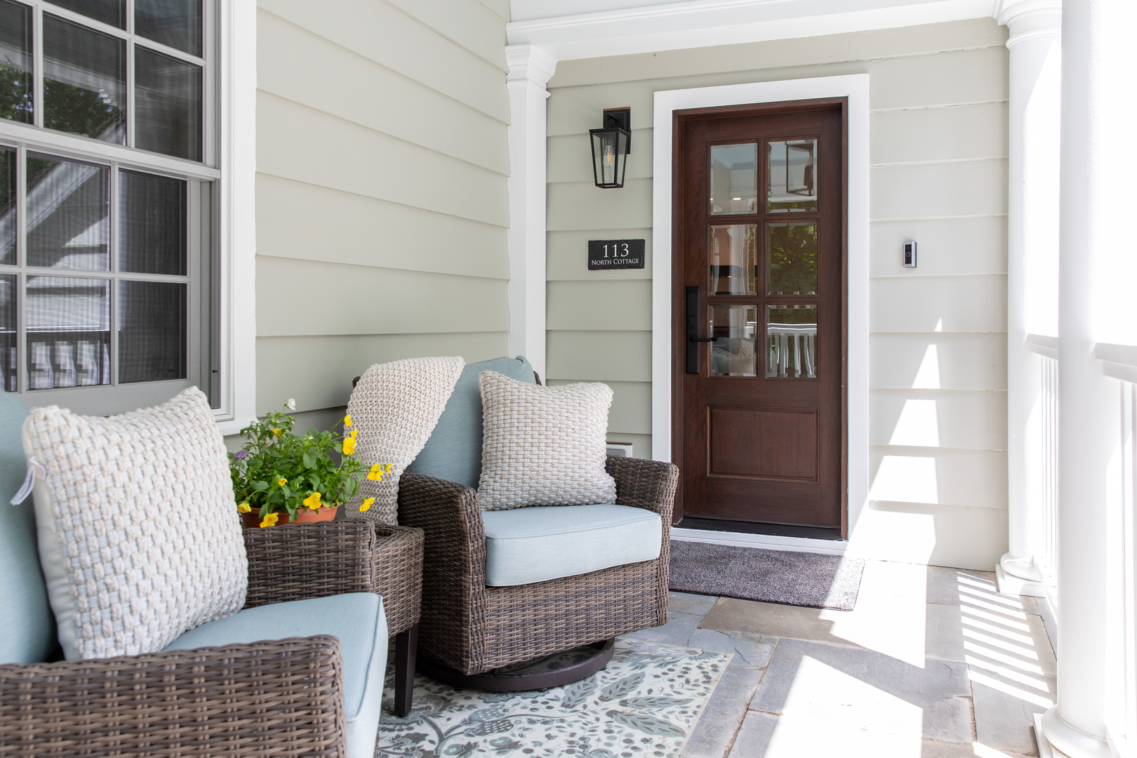 a living room with furniture and a potted plant