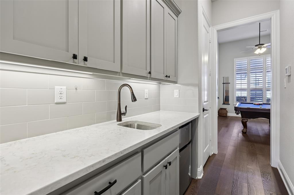 451 Morgan Lane Prosper, TX 75078 - Photo 11 of 38 a kitchen with a sink and cabinets