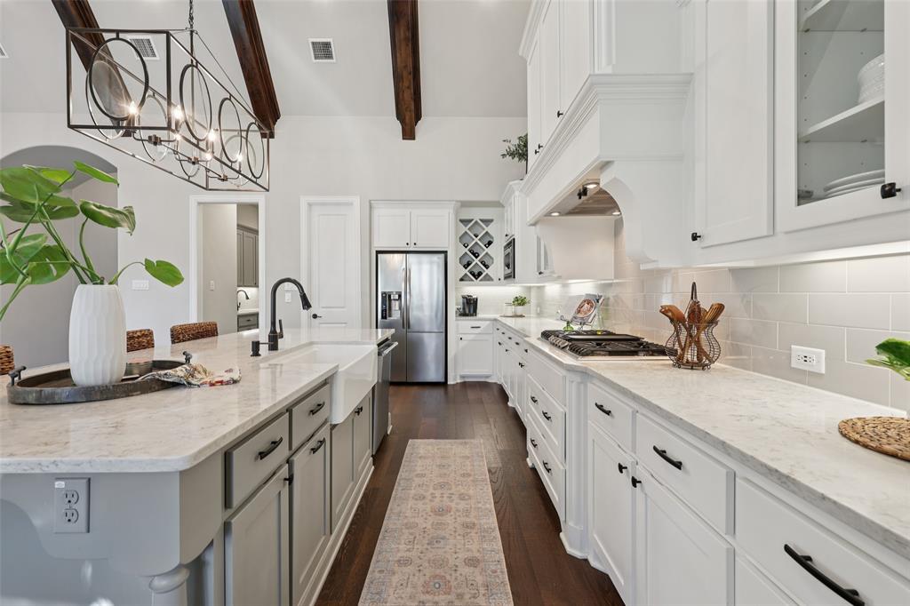 451 Morgan Lane Prosper, TX 75078 - Photo 14 of 38 a kitchen with stainless steel appliances granite countertop a sink a stove and cabinets