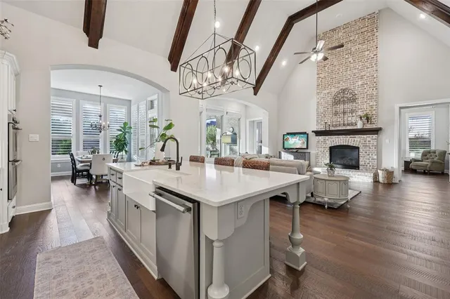 a living room with furniture a fireplace and wooden floor