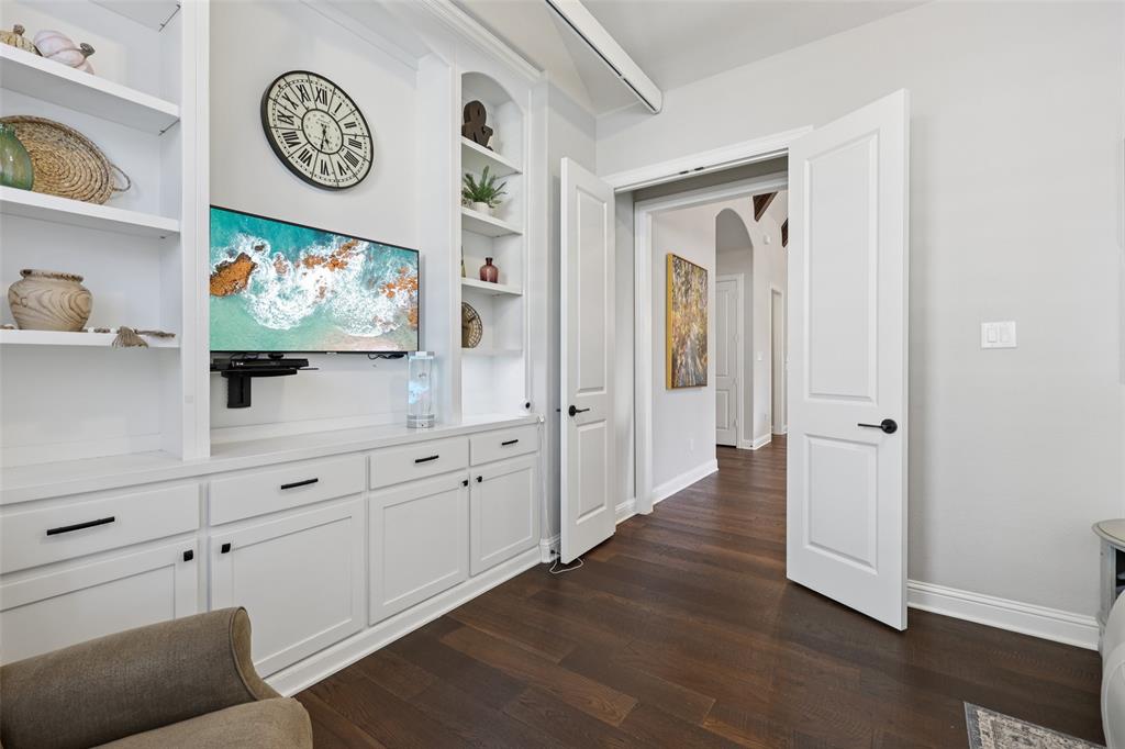 451 Morgan Lane Prosper, TX 75078 - Photo 17 of 38 a view of a hallway with painting on the wall and a wooden floor