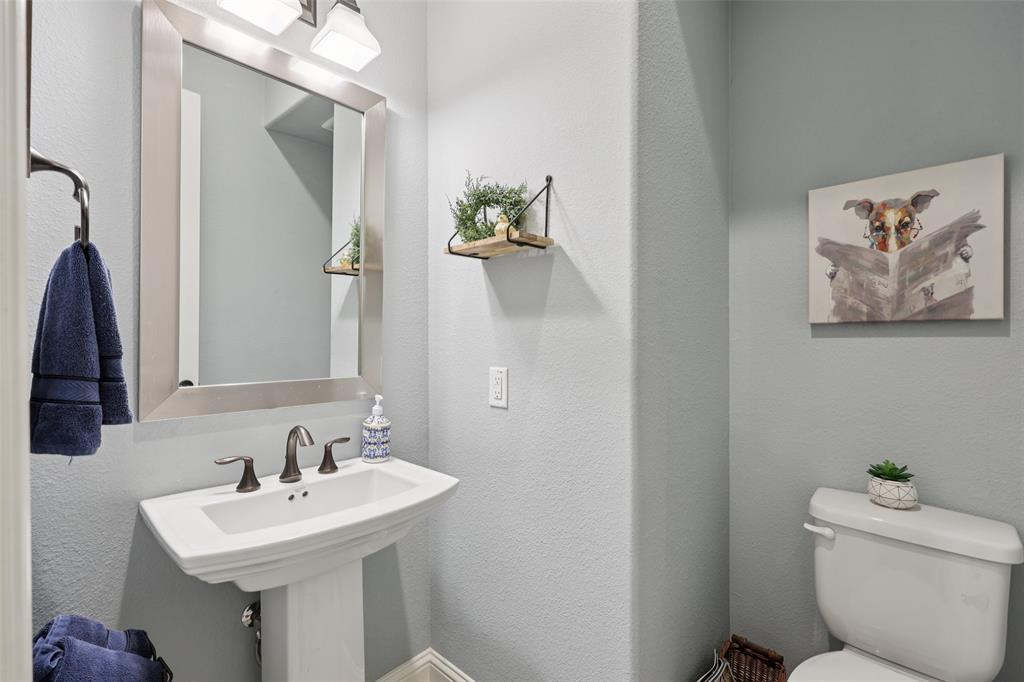 451 Morgan Lane Prosper, TX 75078 - Photo 19 of 38 a bathroom with a toilet a sink and mirror