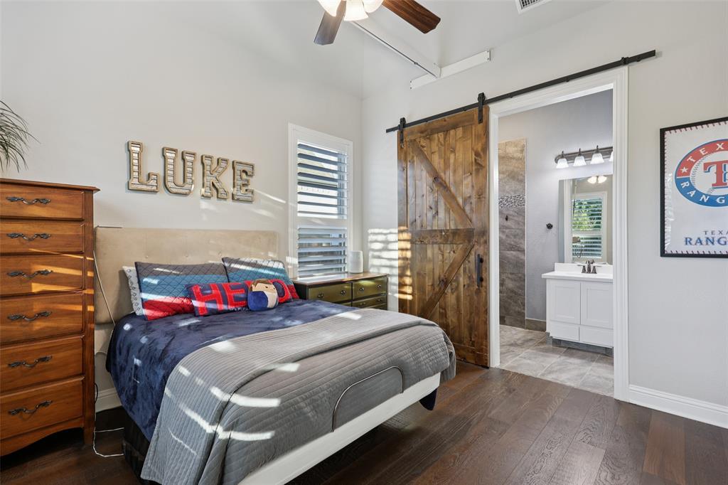 451 Morgan Lane Prosper, TX 75078 - Photo 24 of 38 a bedroom with a bed and a chandelier