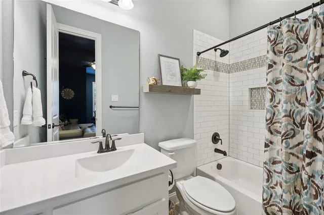a bathroom with a sink toilet a shower and a mirror