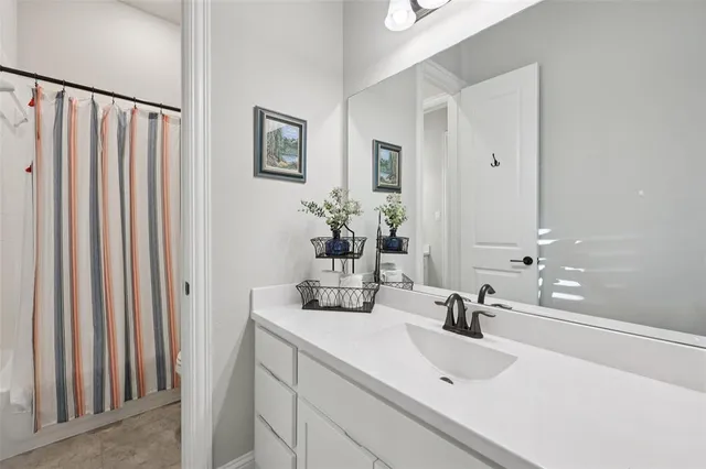 a bathroom with a double vanity sink and a mirror