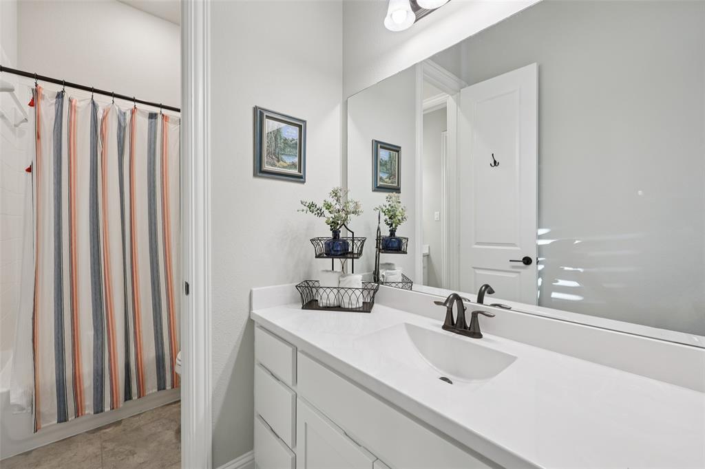 451 Morgan Lane Prosper, TX 75078 - Photo 31 of 38 a bathroom with a double vanity sink and a mirror